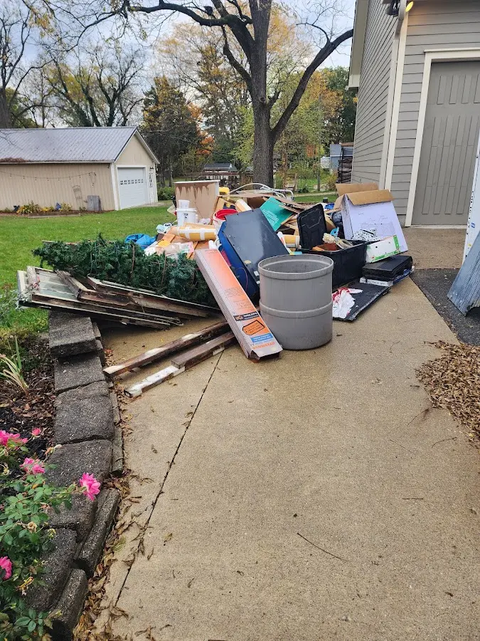 Dumpster being loaded with debris for 12 Yard Dumpster Rental in Warrington